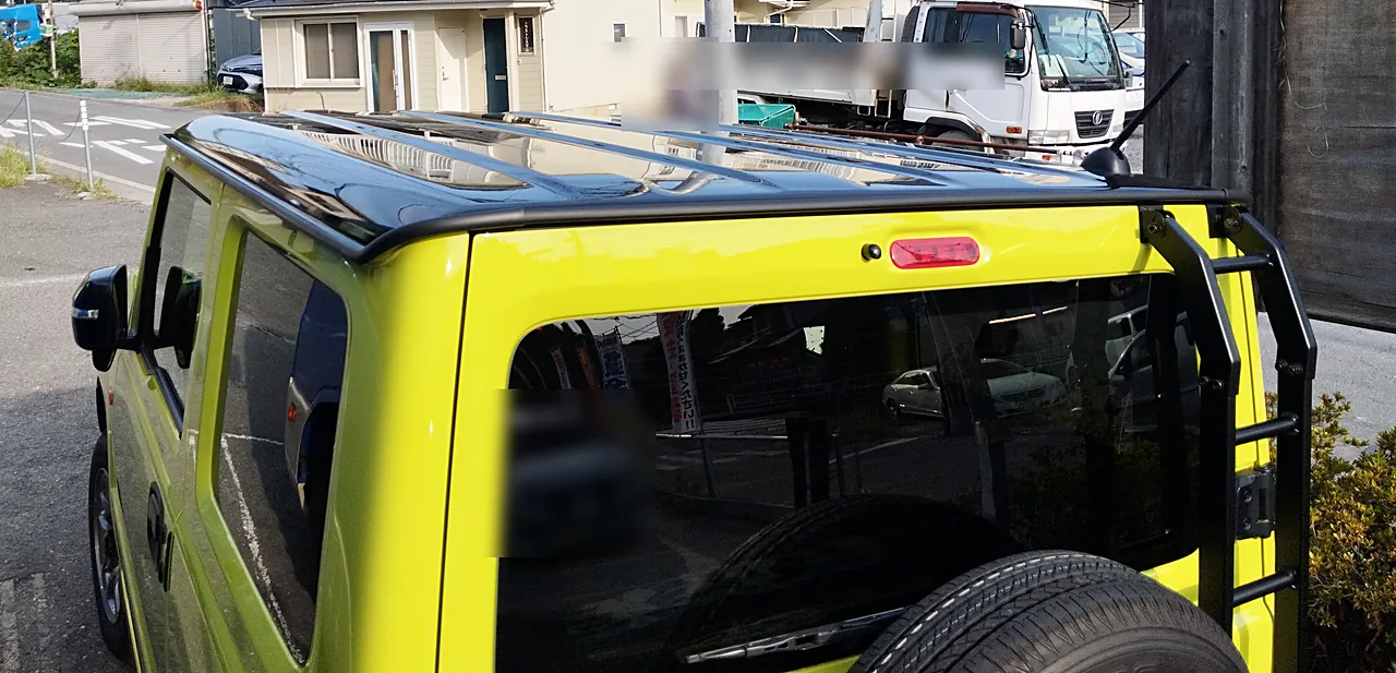 修理を終えたジムニー（JB64）を左後ろから。黄色い車体に黒い屋根（完成・屋外）